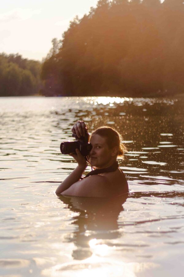 ciałożyczliwa fotografka podczas sesji zdjęciowej w jeziorze
